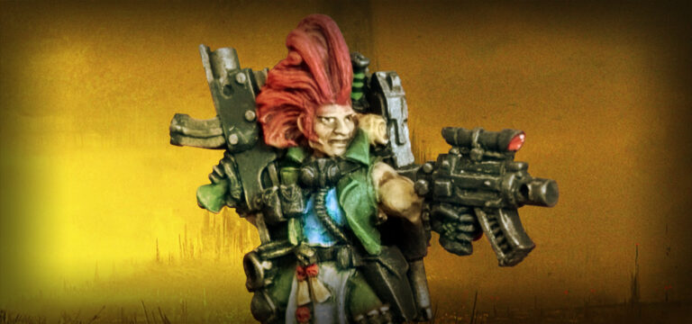 Fotografía de una miniatura de Necromunda. Es un cazarrecompensas clásico de metal, de pelo rojo punkarra, armado hasta los dientes con armas bolter y vestido con un uniforme verde militar. Se trata de un dramatis personae llamado Tariann Norris.