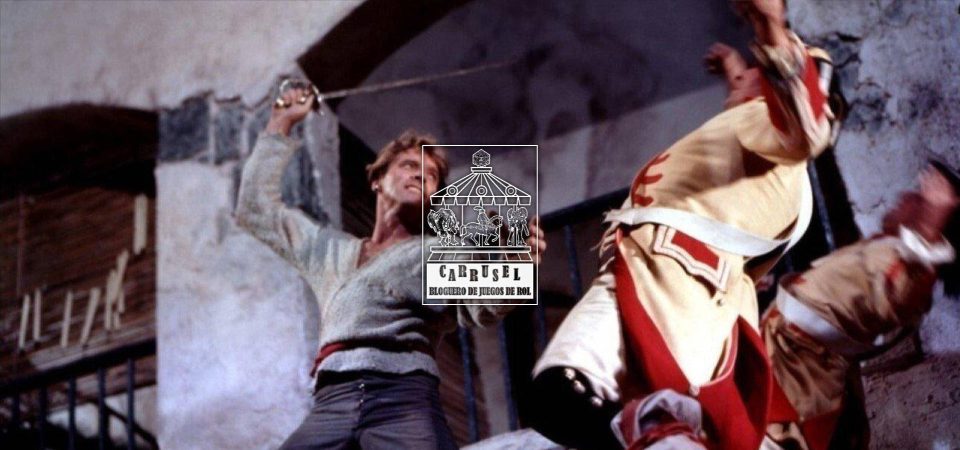 Fotograma de El temible burlón, en el que con una vista en contrapicado Burt Lancaster, con expresión de mala pipa y vestido con una camisa gris, cinturón rojo y pantalón azul, despacha con un estoque sobre la cabeza a dos guardias con casacas amarillas y rojas. Está aquí porque las de piratas son buenas ambientaciones para empezar en el rol. En el centro sobre la foto está el logo de la iniciativa Carrusel: un rectángulo vertical con un tiovivo de feria coronado por un dado de 20 caras, cuyas monturas son una imagen de Cthulhu, un caballero armado a caballo y una armadura de combate tecnológica. Bajo el tiovivo aparecen las letras grandes CARRUSEL ondulando arriba y abajo, y bajo esas, ocupando el mismo ancho, BLOGUERO DE JUEGOS DE ROL.