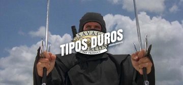 Fotograma de la película El guerrero americano, American Ninja. En contrapicado, el actor Michael Dudikoff, vestido con el traje clásico ninja negro que sólo le deja a la vista las manos y los ojos, empuñando dos sais con ambas manos. Seguramente esto no se parezca en nada a un ninja de verdad, pero para Tipos Duros esto es el prototipo de ninja que se convierte en extras para Savage Worlds.